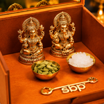 Brass Lakshmi and Ganesh idols with cardamom, misri and a festive key