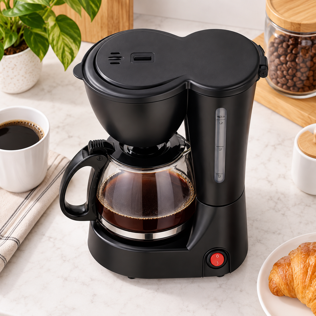 6 Cup Drip Coffee Maker with glass carafe, filled with coffee
