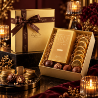 Aurum Noir Luxe Hamper closed gold gift box with satin ribbon next to the open box